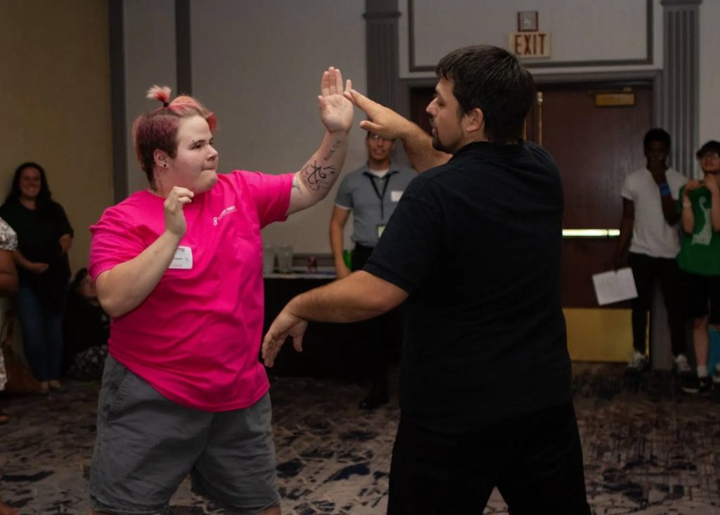David and a young person demonstrating martial arts during a breakout session at the Indiana Foster Youth Alliance’s (IFYA) Annual Youth Conference